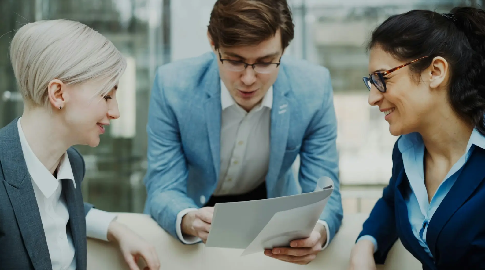 Team discussing fundraising strategy while reviewing documents together.